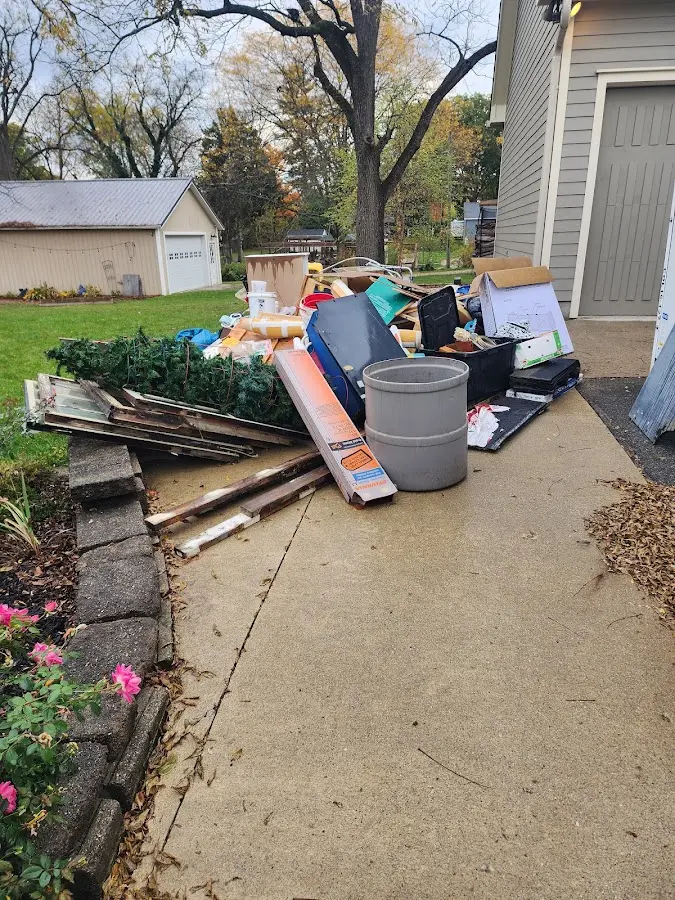 Dumpster being loaded with debris for Roofing Dumpster Rental in Garwood